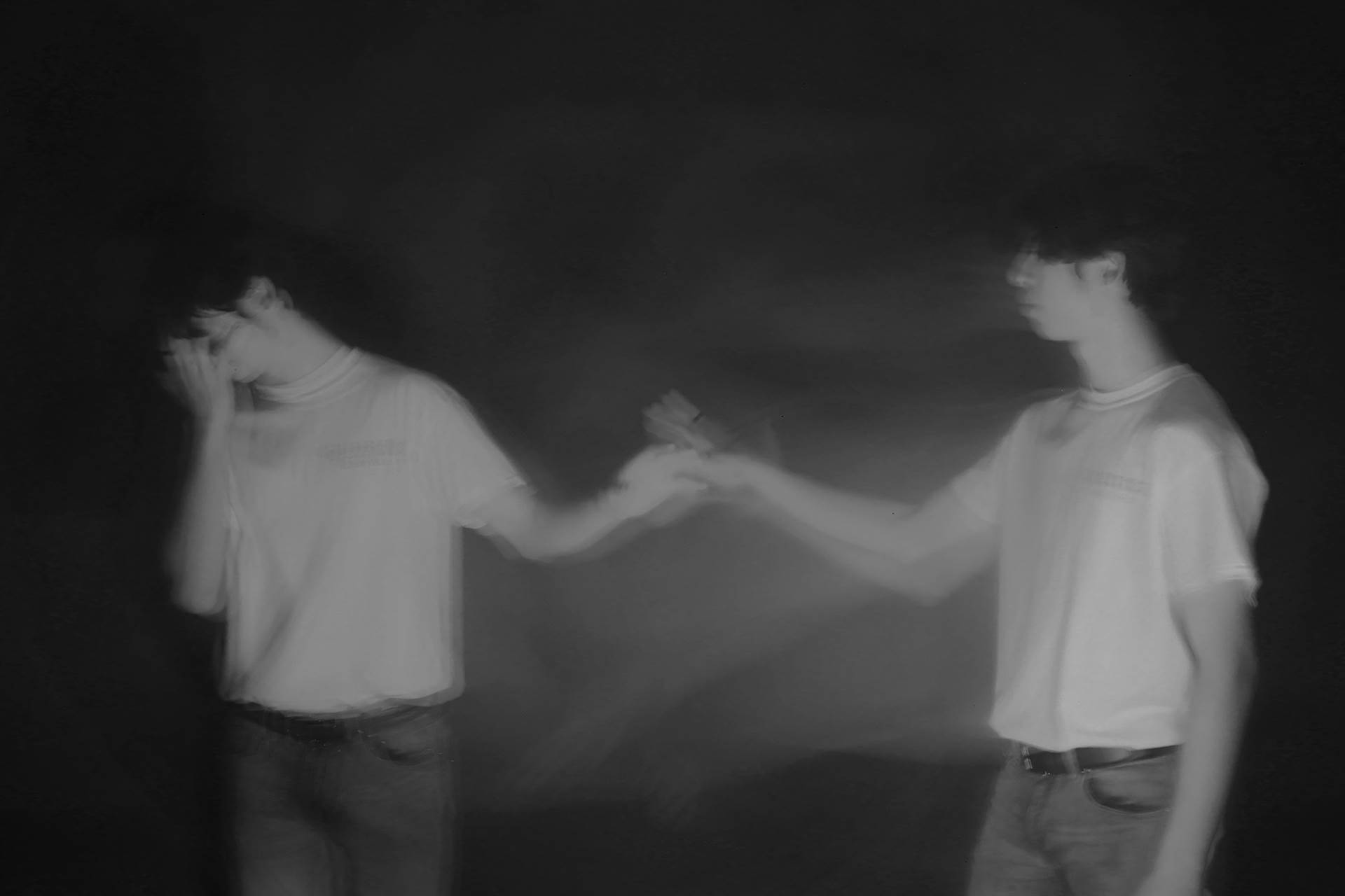 Black and white photo of 2 teams holding hands