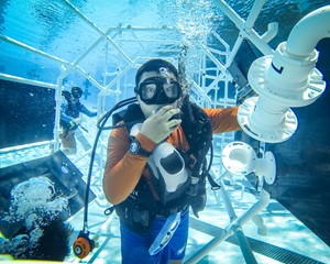 Student in scuba gear. building underwater.