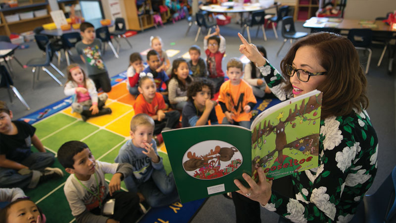 Teacher reading to young students